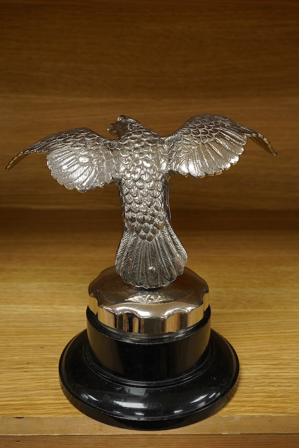 A large chromed eagle car mascot, mounted on a large radiator cap and turned socle, height 21.5cm. Condition - good.